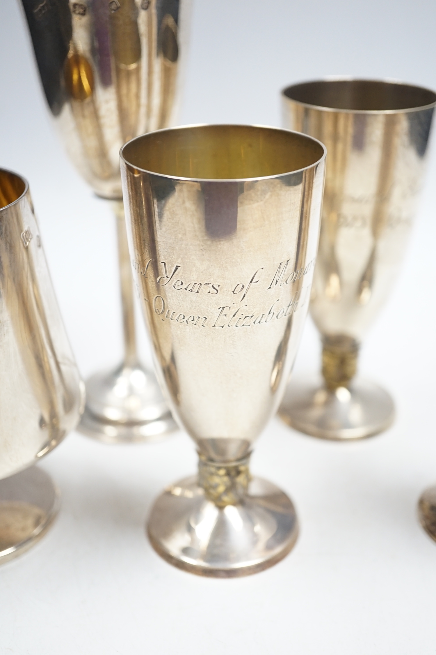 A pair of modern silver commemorative pedestal goblets, '1000 Years of Monarchy', by Mappin & Webb, London, 1973, 13.2cm and three other modern silver goblets, 30.8oz.